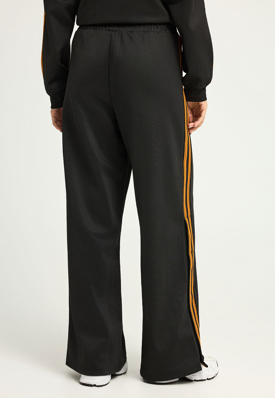 Pantaloni jogger cu croi larg și bandă laterală