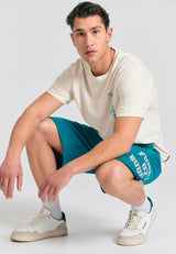 Wide leg fit sports shorts with branded print - Peacock